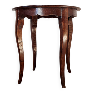 Vintage solid wood side table with curved legs.