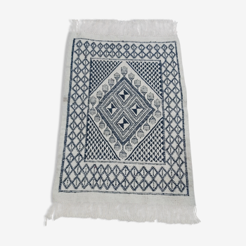 Traditional white and blue hand-woven wool carpet