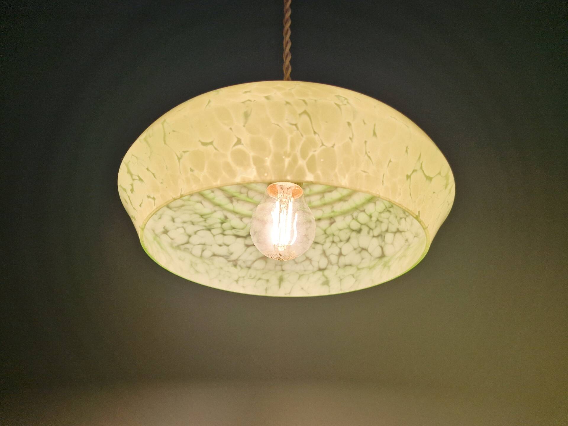 Pair of Art Deco light fixtures in light green speckled glass, 1930s.