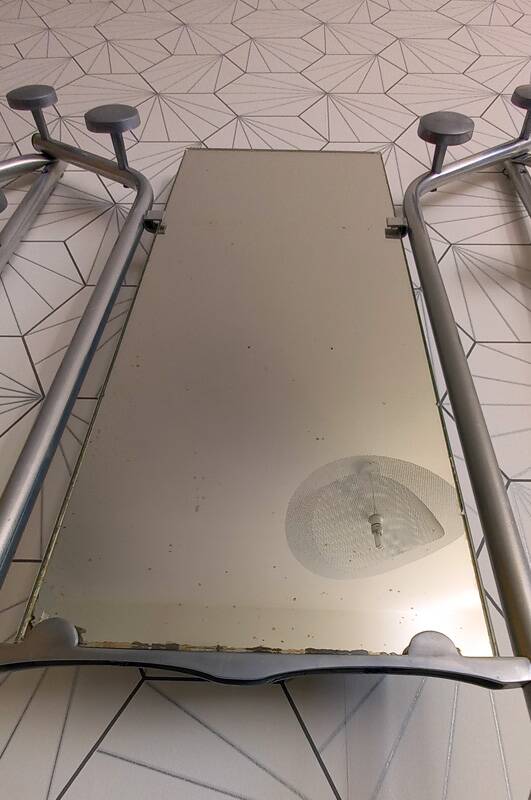 Vintage aluminum wall coat rack.