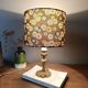 brass table lamp | khaki lampshade with multicoloured daisies