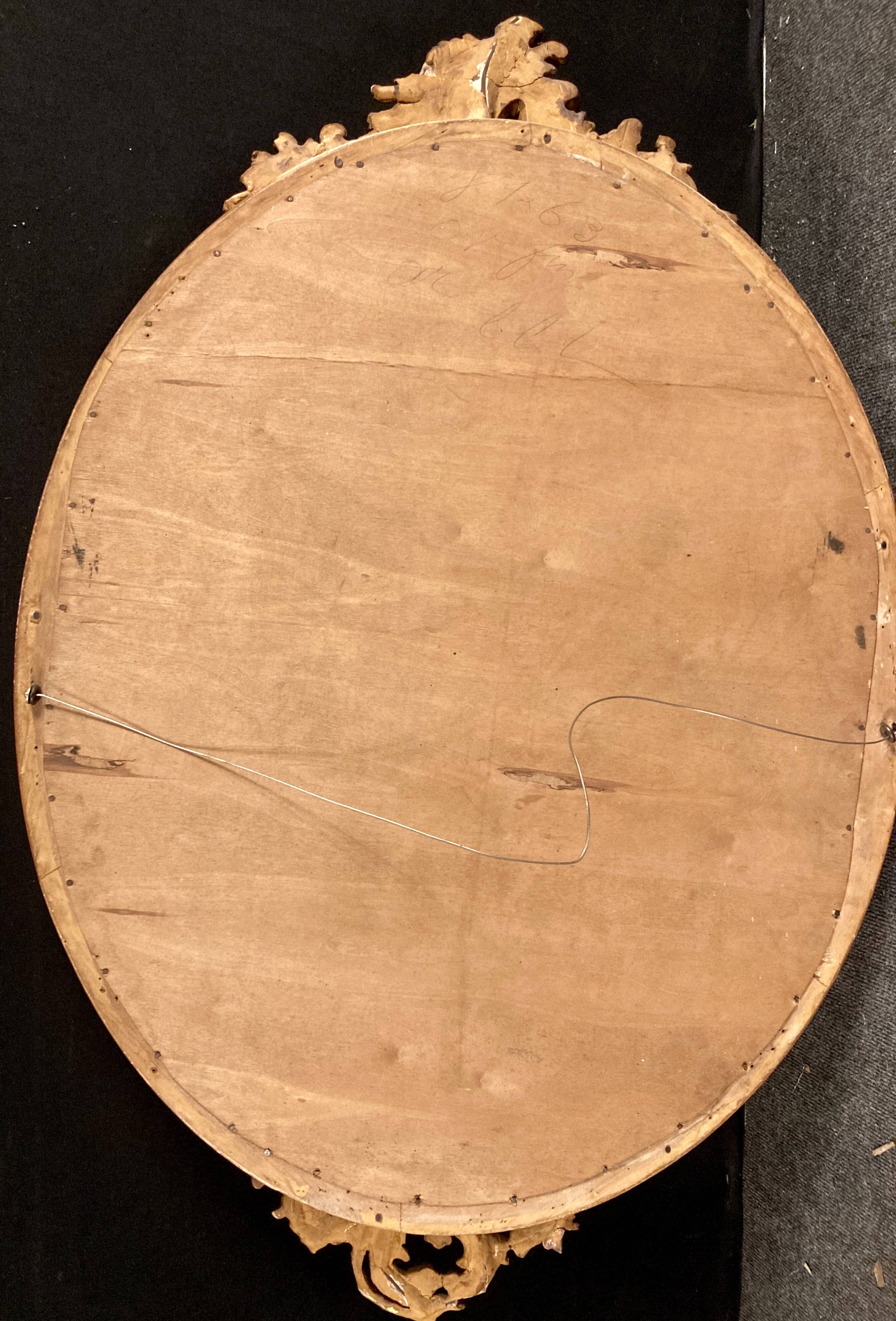 Large oval mirror in gilded wood
