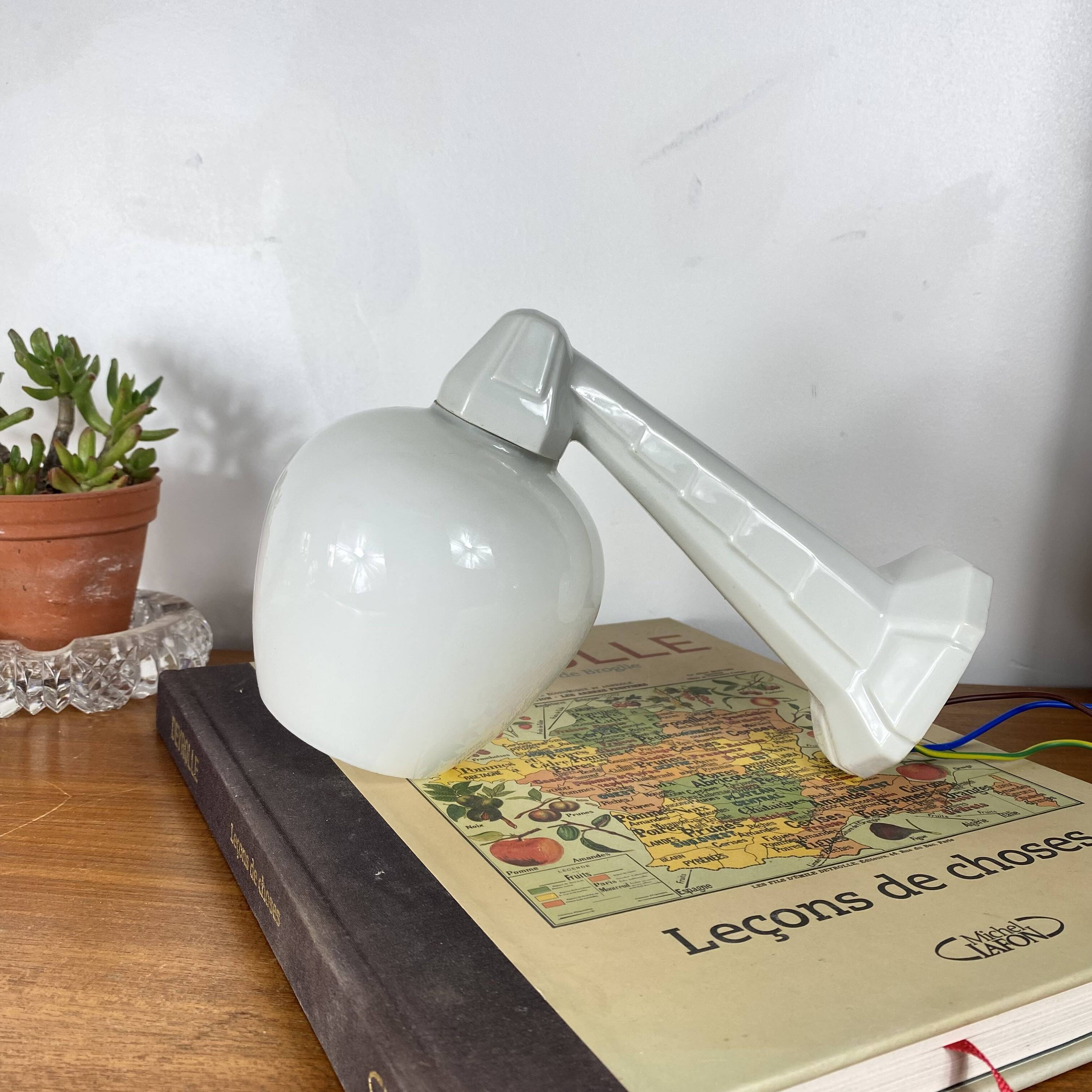 Swan neck wall light in ceramic with an opaline white glass globe.