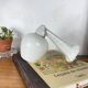 Swan neck wall light in ceramic with an opaline white glass globe.
