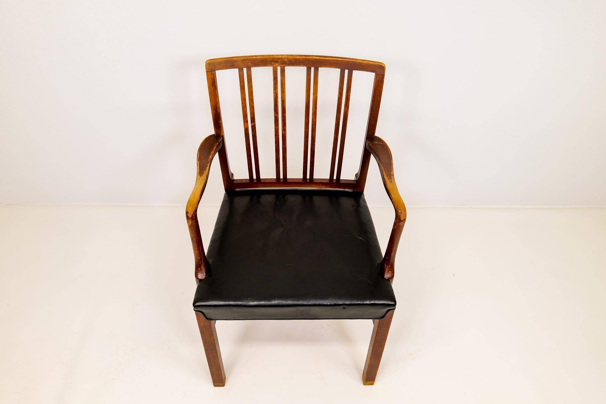 Mid-century armchair by Ole Wanscher for Fritz Hansen, stained beech and leather.