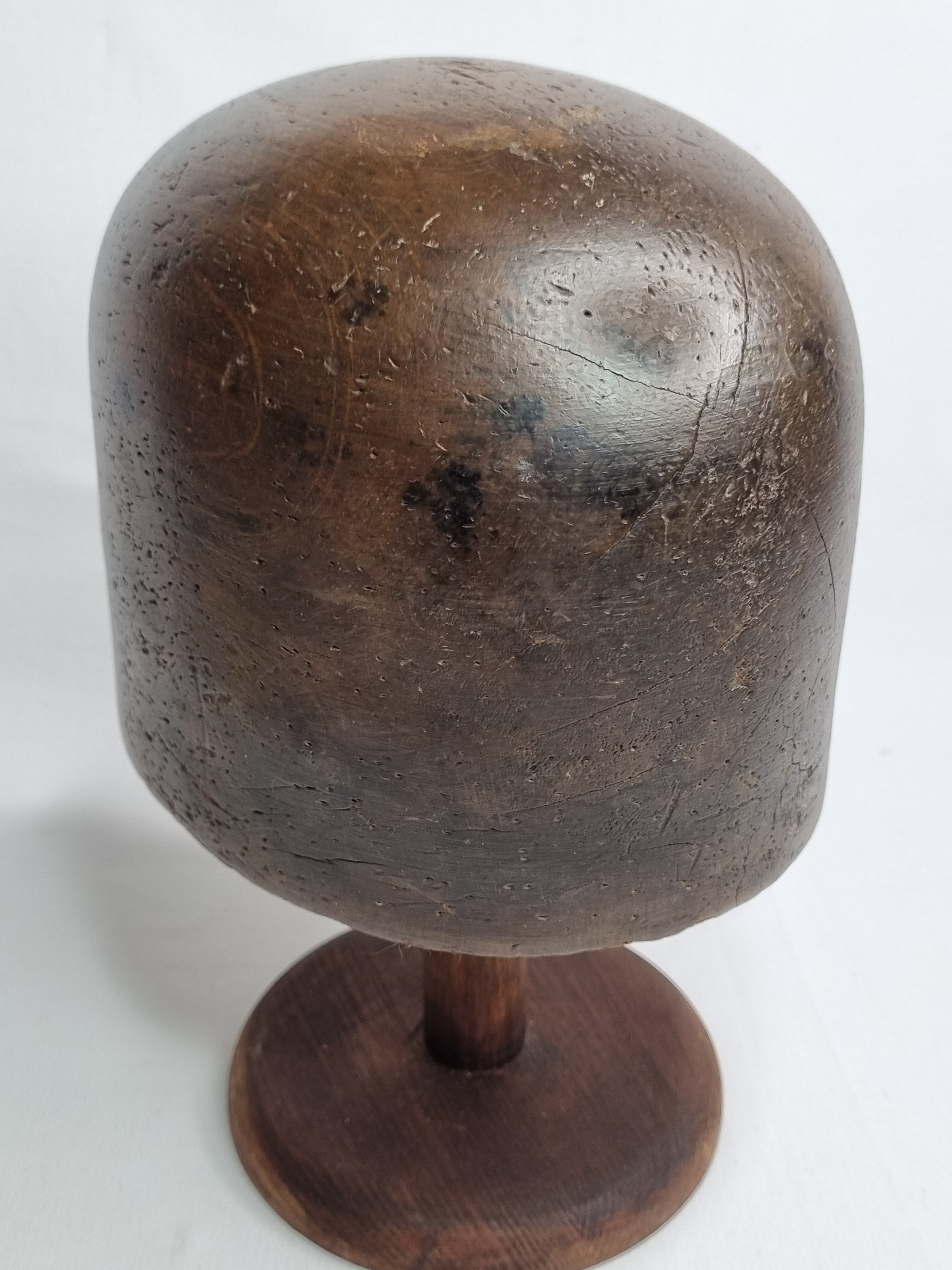 Old solid wood hat shape on foot, 1900