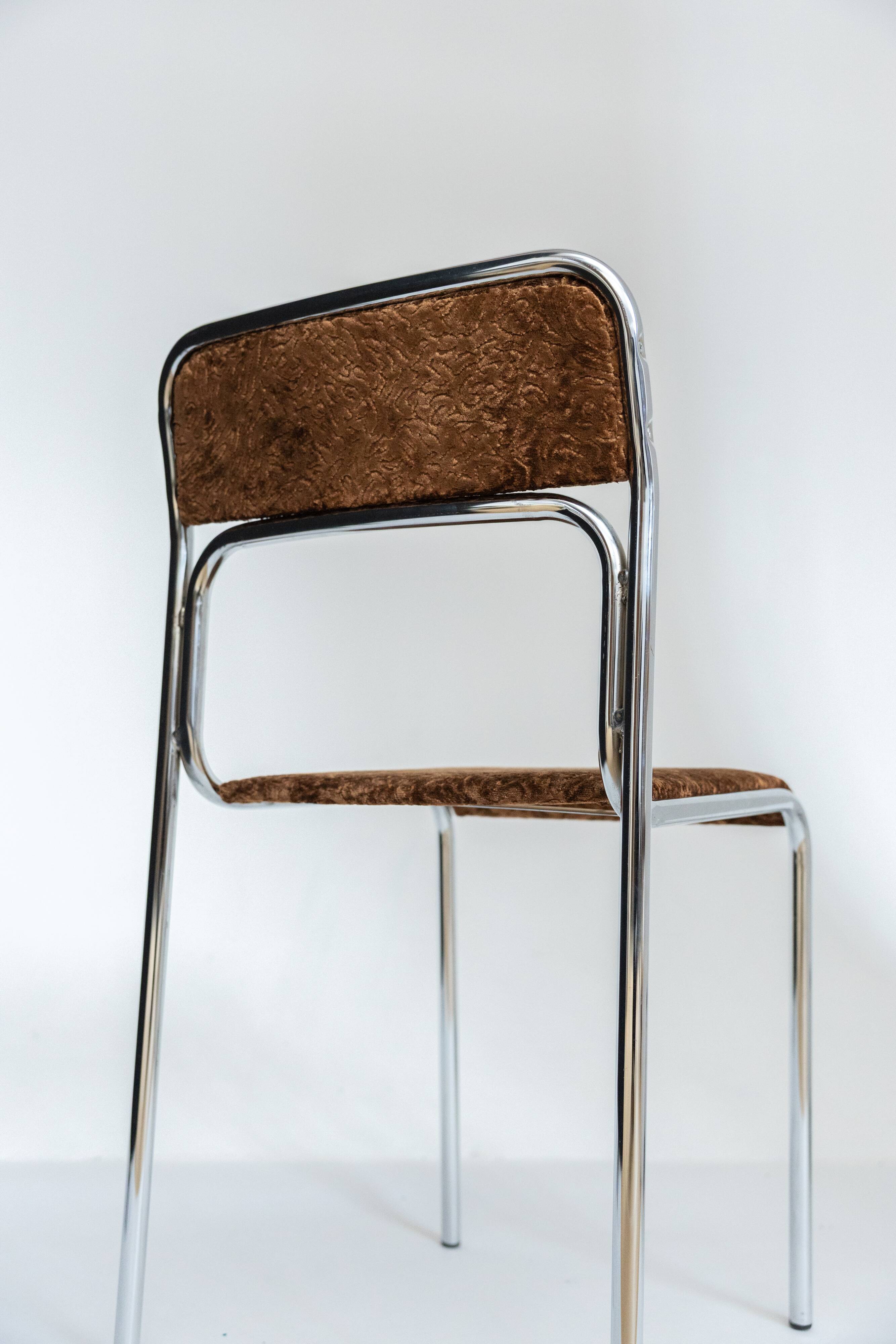 Chrome dining chair upholstered in brown bitten velvet.