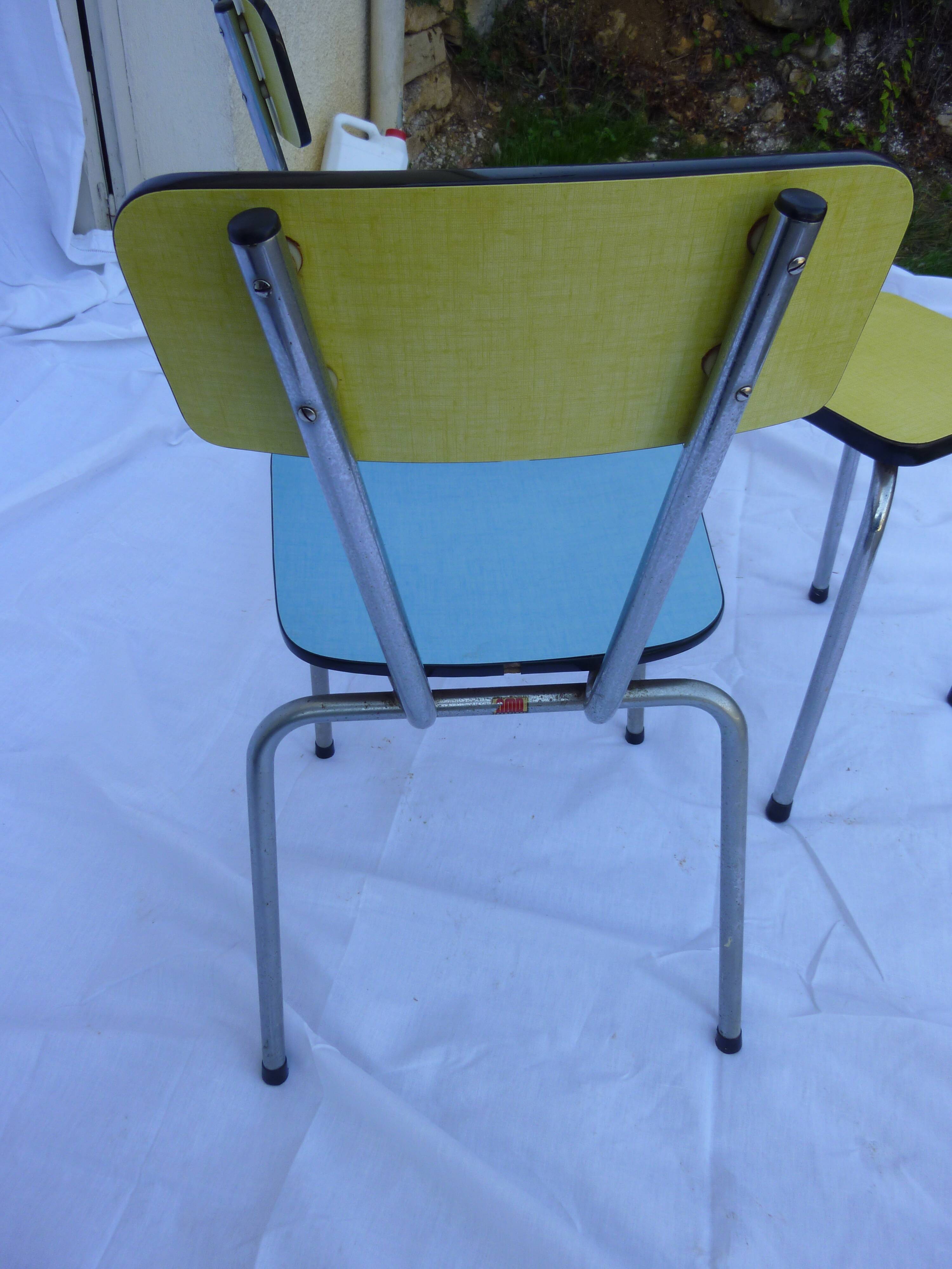 Two chairs and a yellow and blue stool in formica