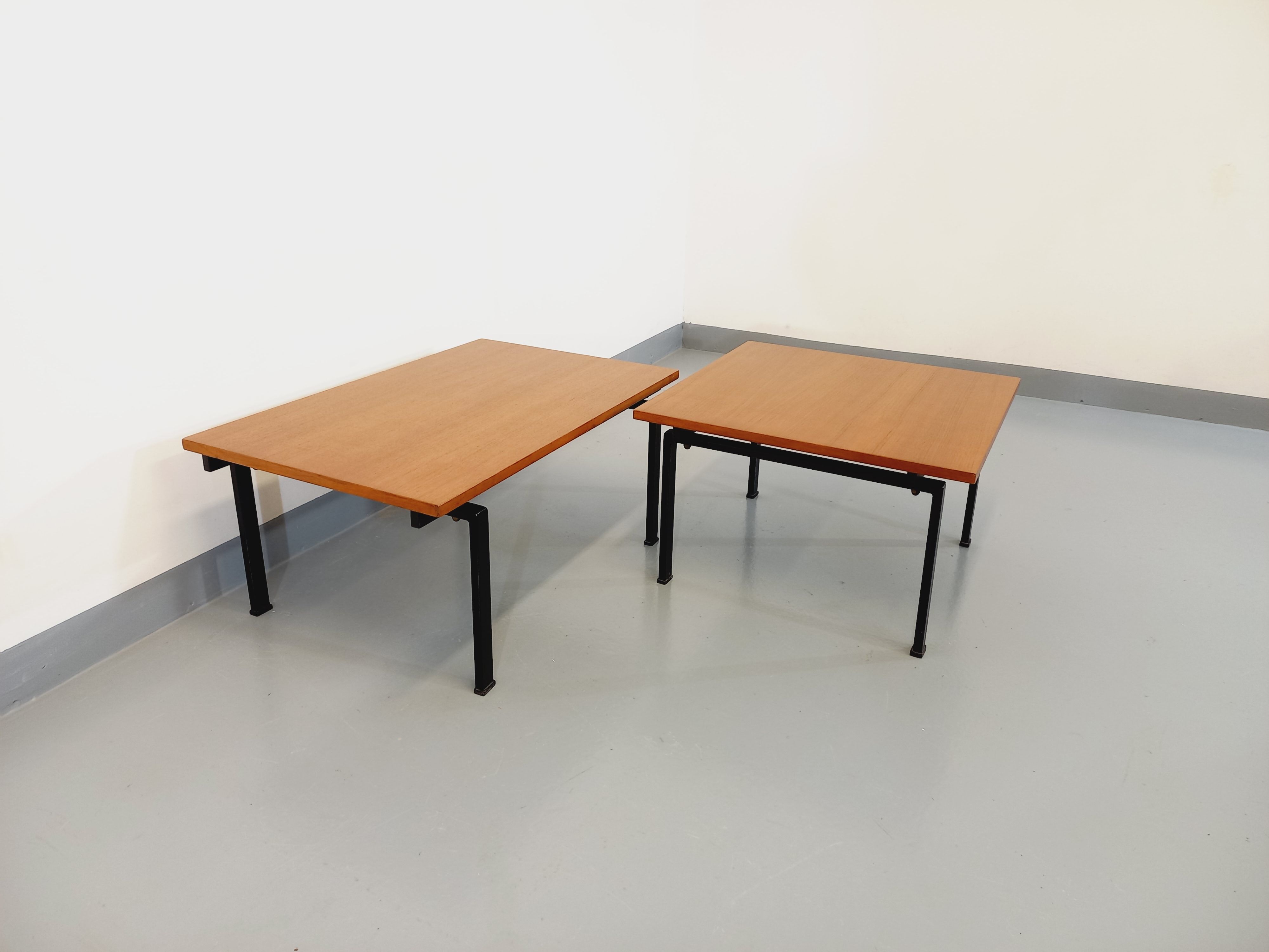 Suite of two vintage modernist Isa coffee tables in teak and black metal from the 60s