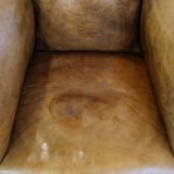 Fauteuil ancien en cuir de mouton