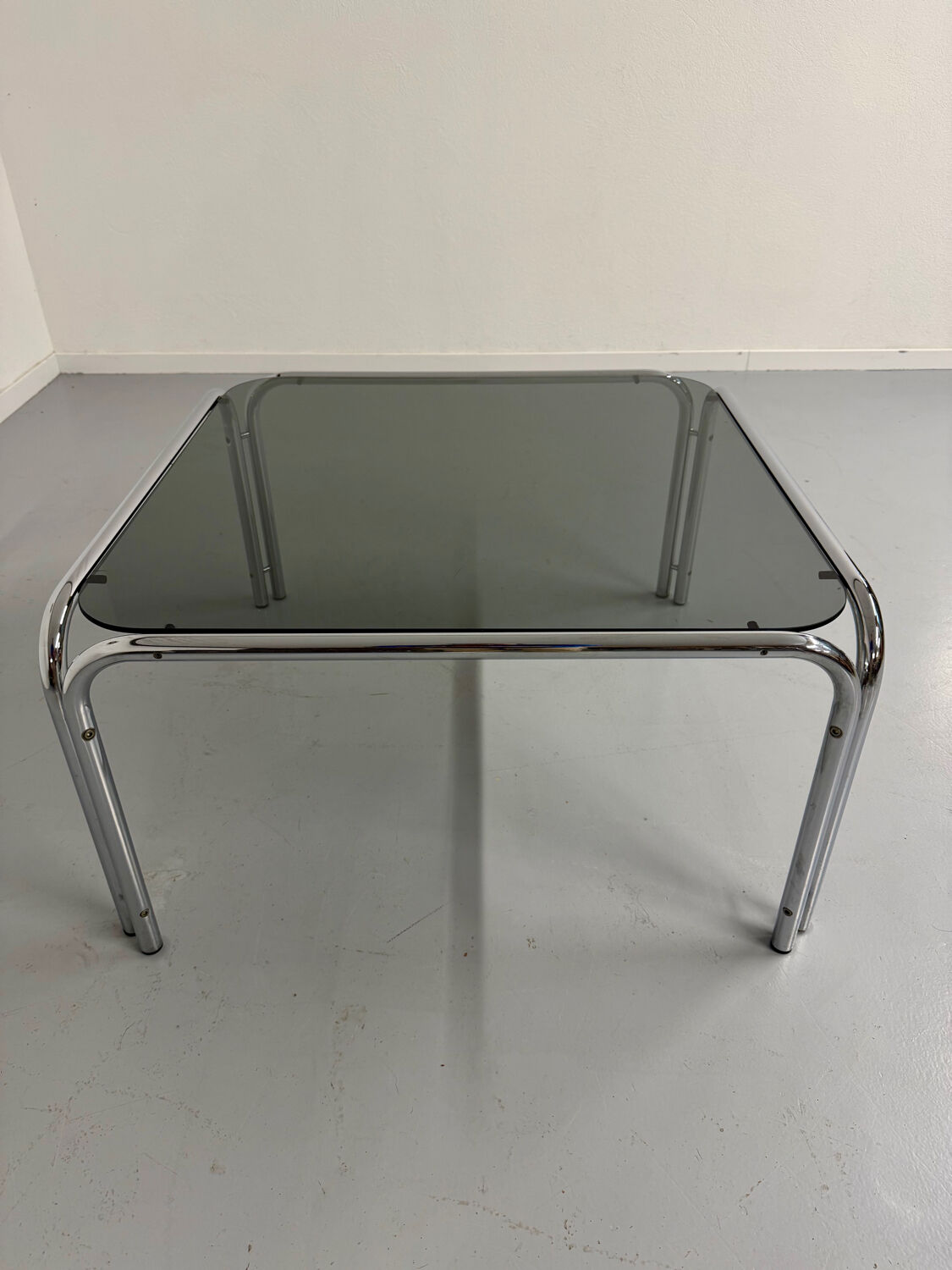 Space coffee table from the 70s, tubular metal and vintage smoked glass