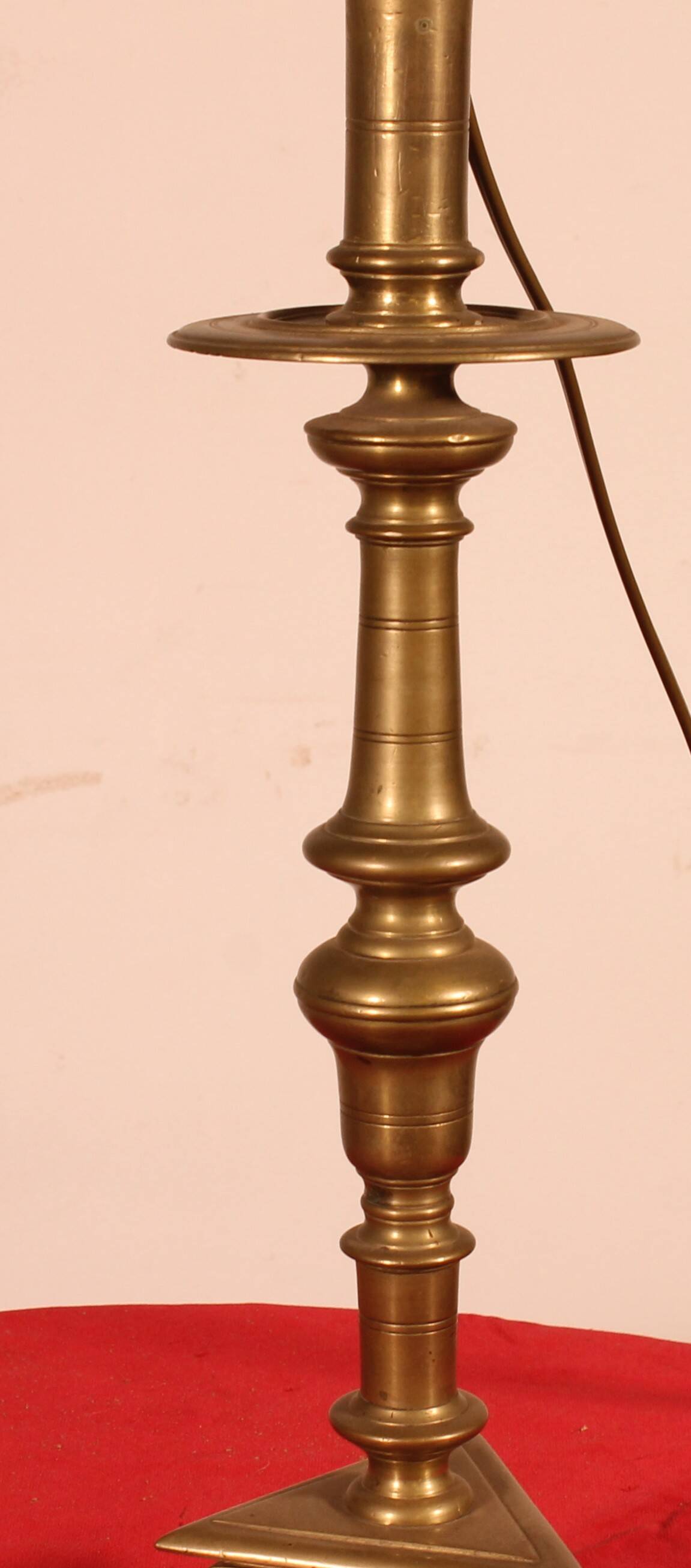 bronze candlestick from the 17th century converted into a lamp with its lampshade