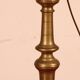 bronze candlestick from the 17th century converted into a lamp with its lampshade