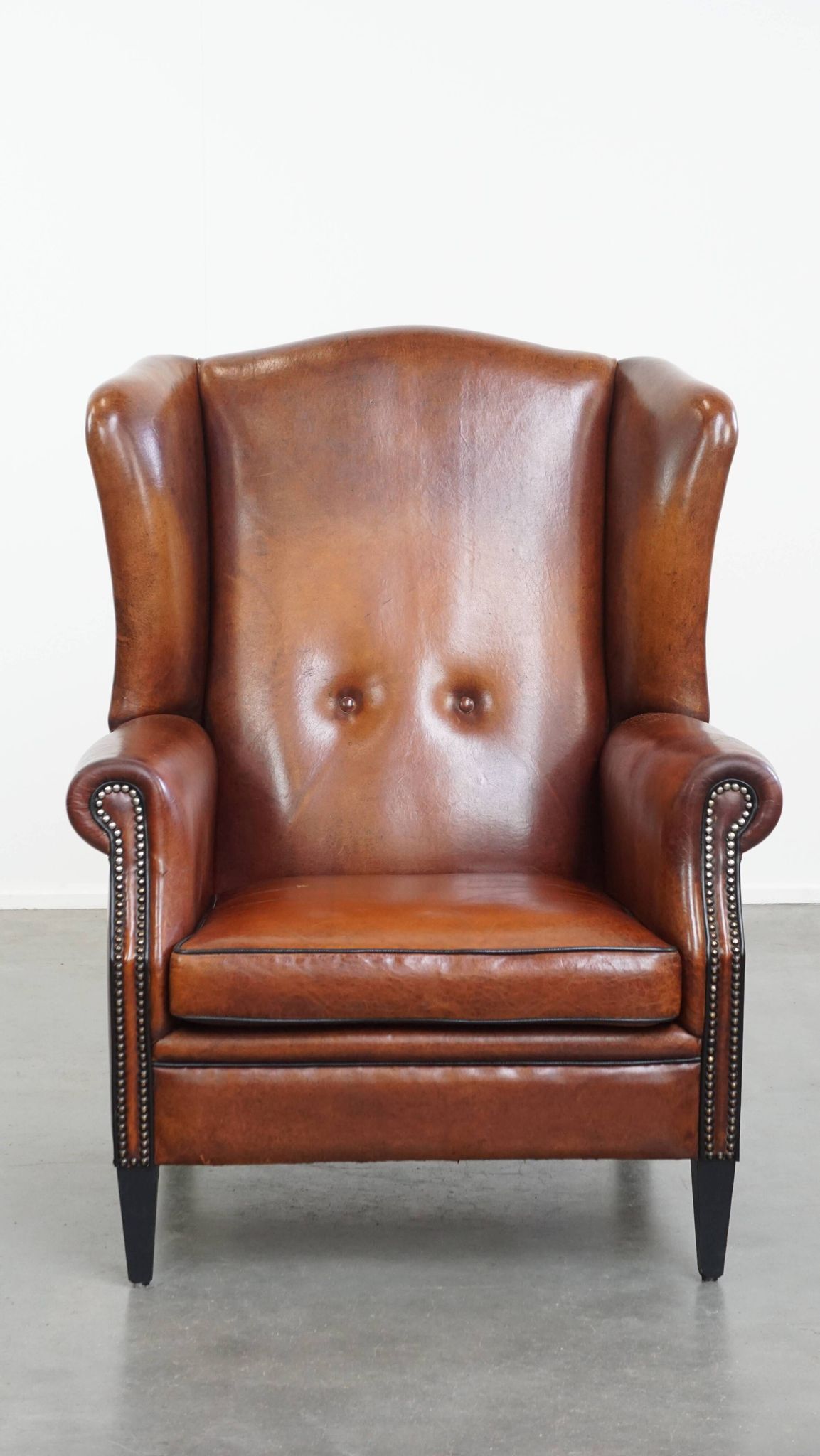 Sheepskin Wingback Chair with Warm Tones and Black Piping
