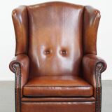 Sheepskin Wingback Chair with Warm Tones and Black Piping