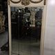 Louis XVI style trumeau mirror with a painted wooden frame.