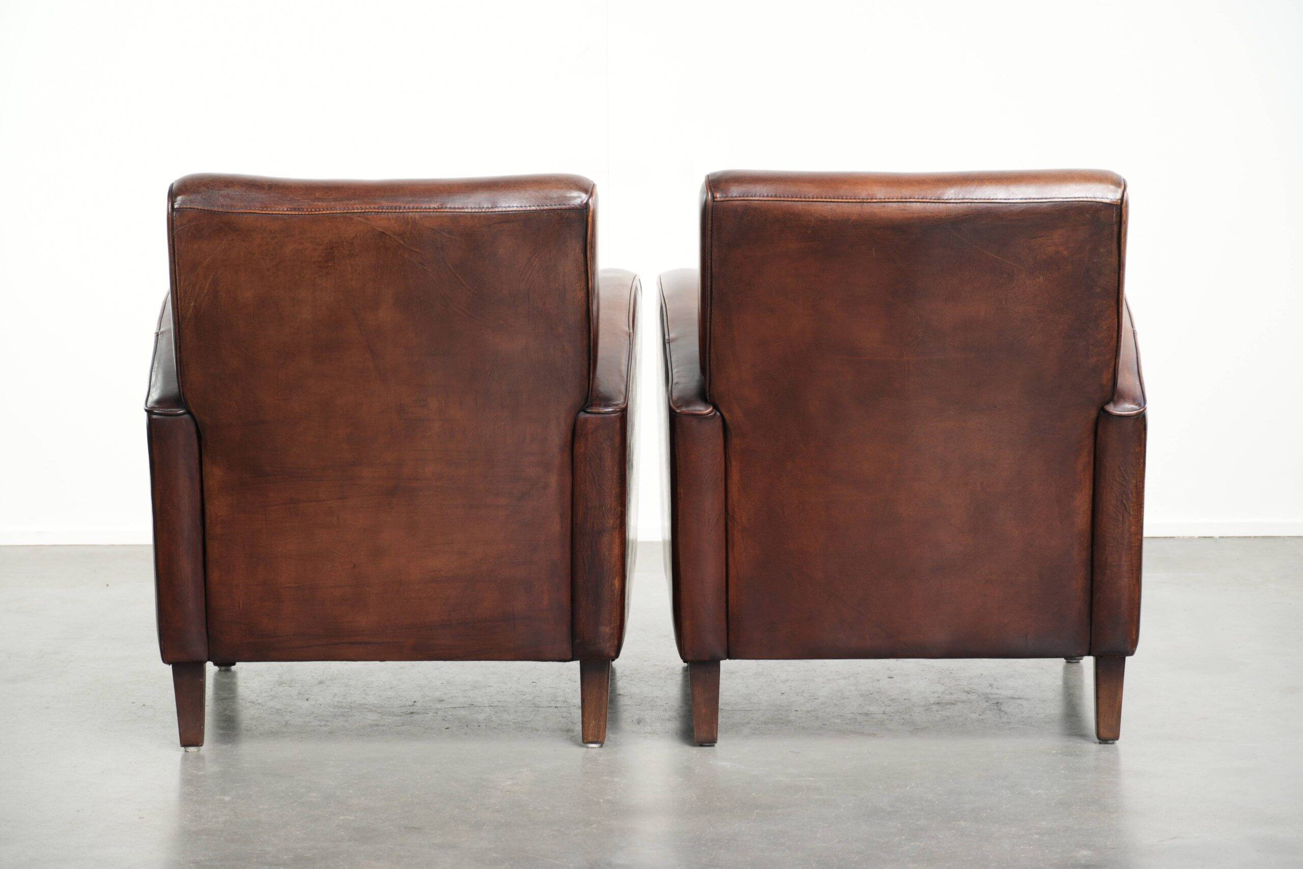 Dark cognac-coloured set of 2 sheepskin armchairs with a sleek design