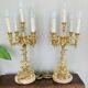 Pair of gilt bronze chandeliers, marble bases.