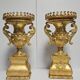 Rare pair of carved and gilded wooden vases, with a refined style inspired by the Empire.