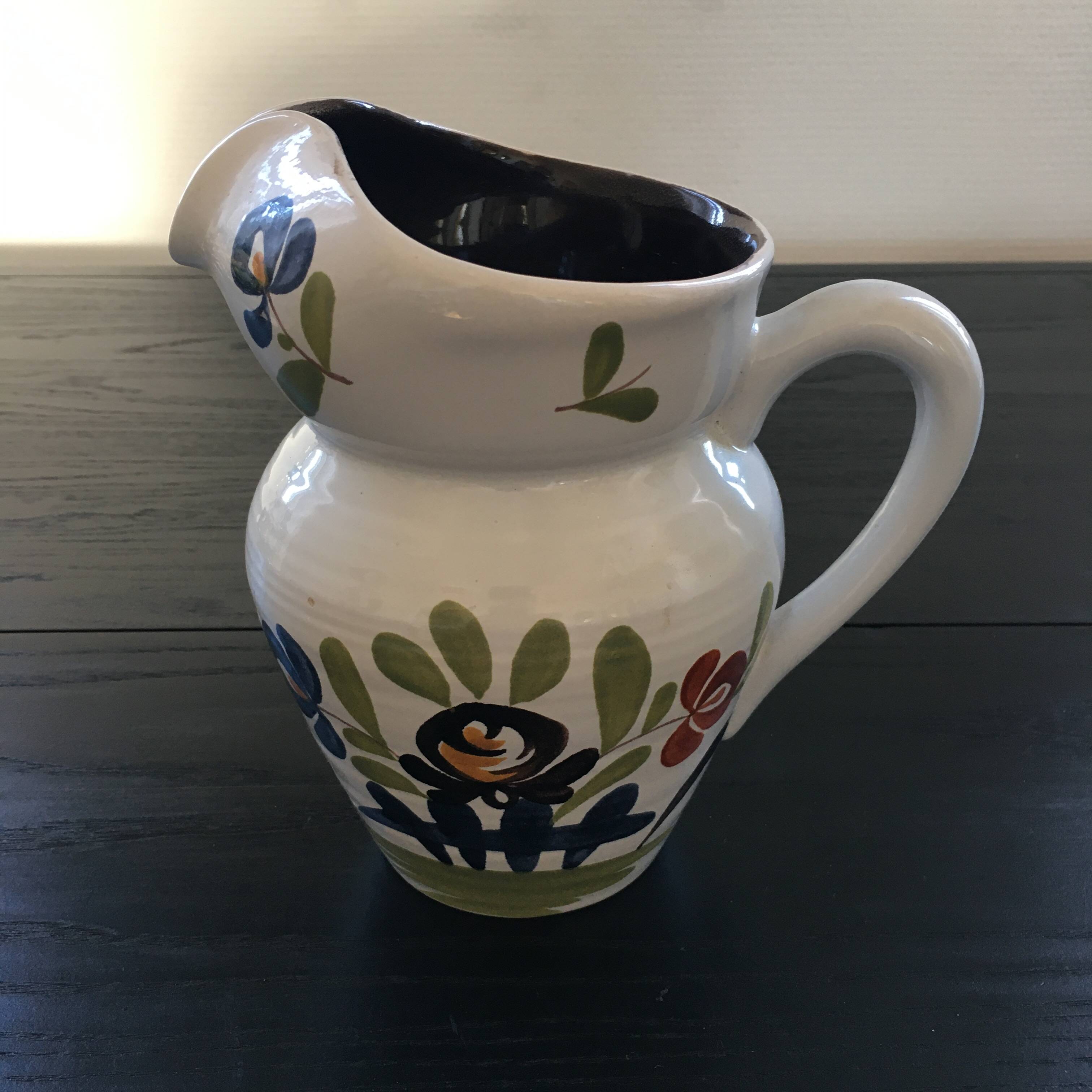 White pitcher with floral decoration