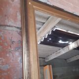 Old mirror of period handmade by cabinetmaking and decorated with gold leaf