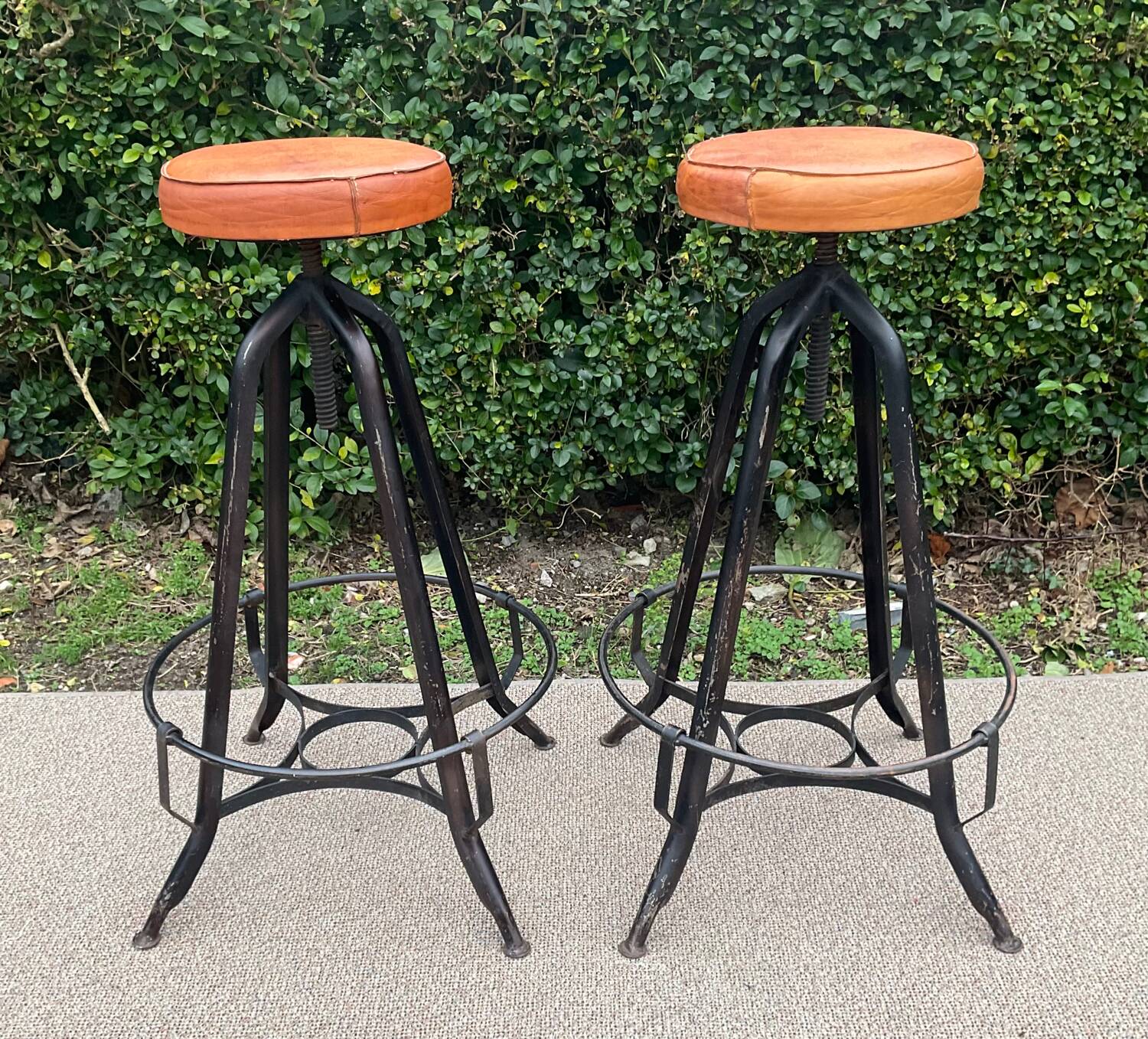 Pair of vintage metal and leather bar stools