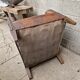 Antique club chair in patinated brown leather, early 20th century English style.
