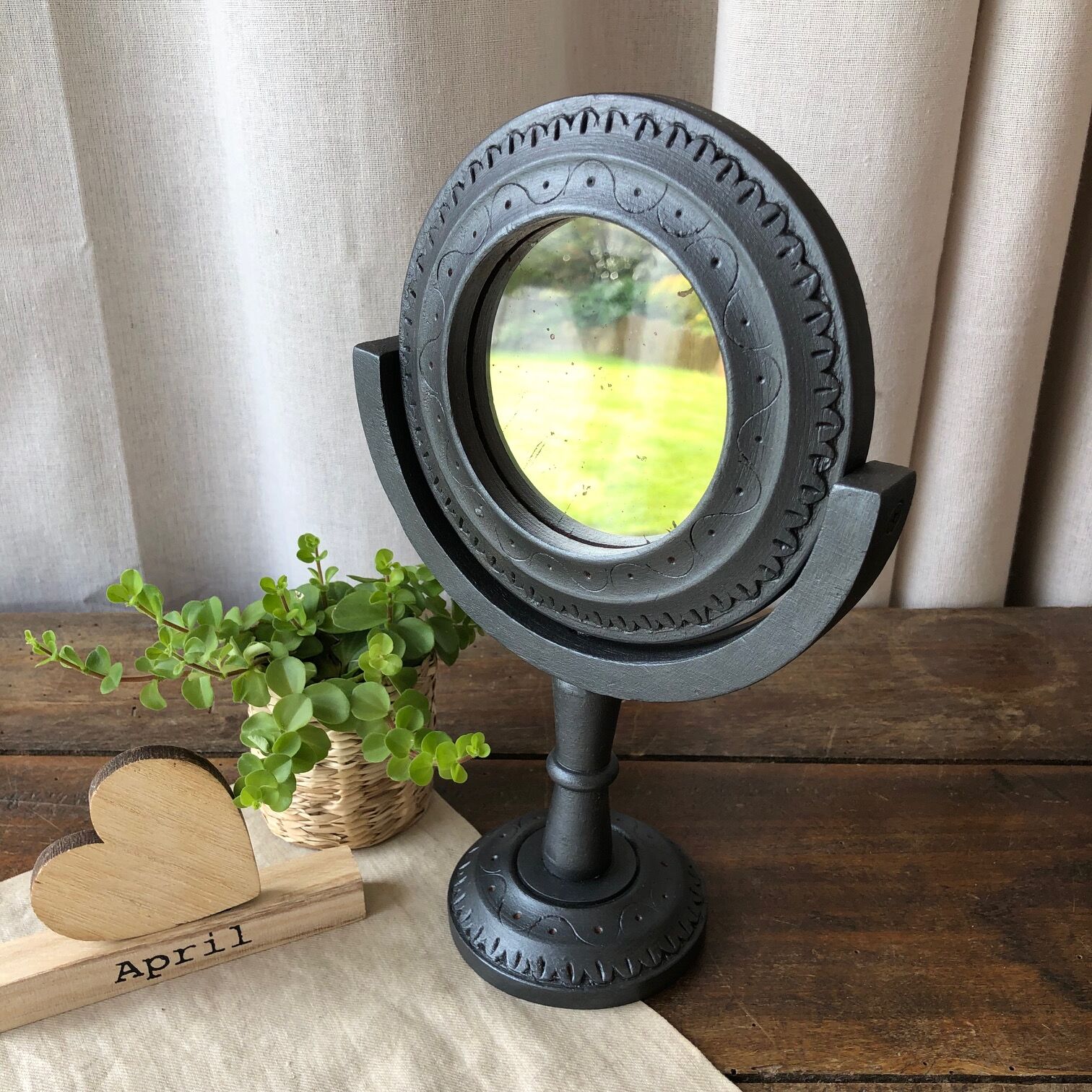 Wooden mirror on foot