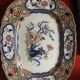Large hollow dish in fine earthenware with Japanese decoration.