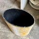 Oval paper bin in woven ochre and grey cotton