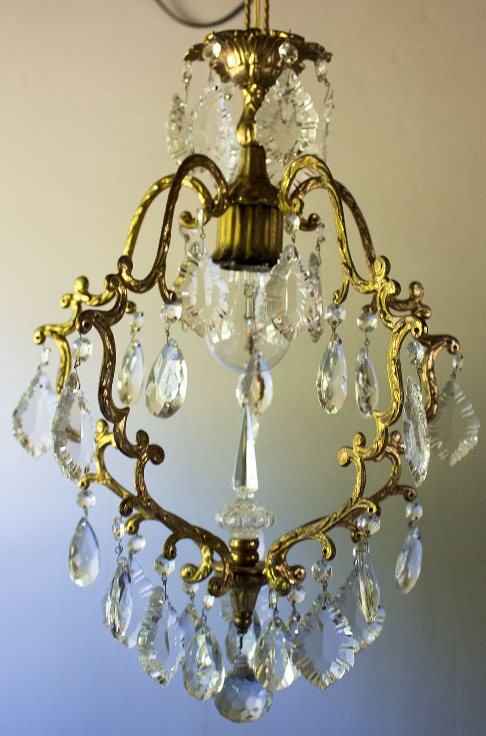 Old brass chandelier with glass stamps