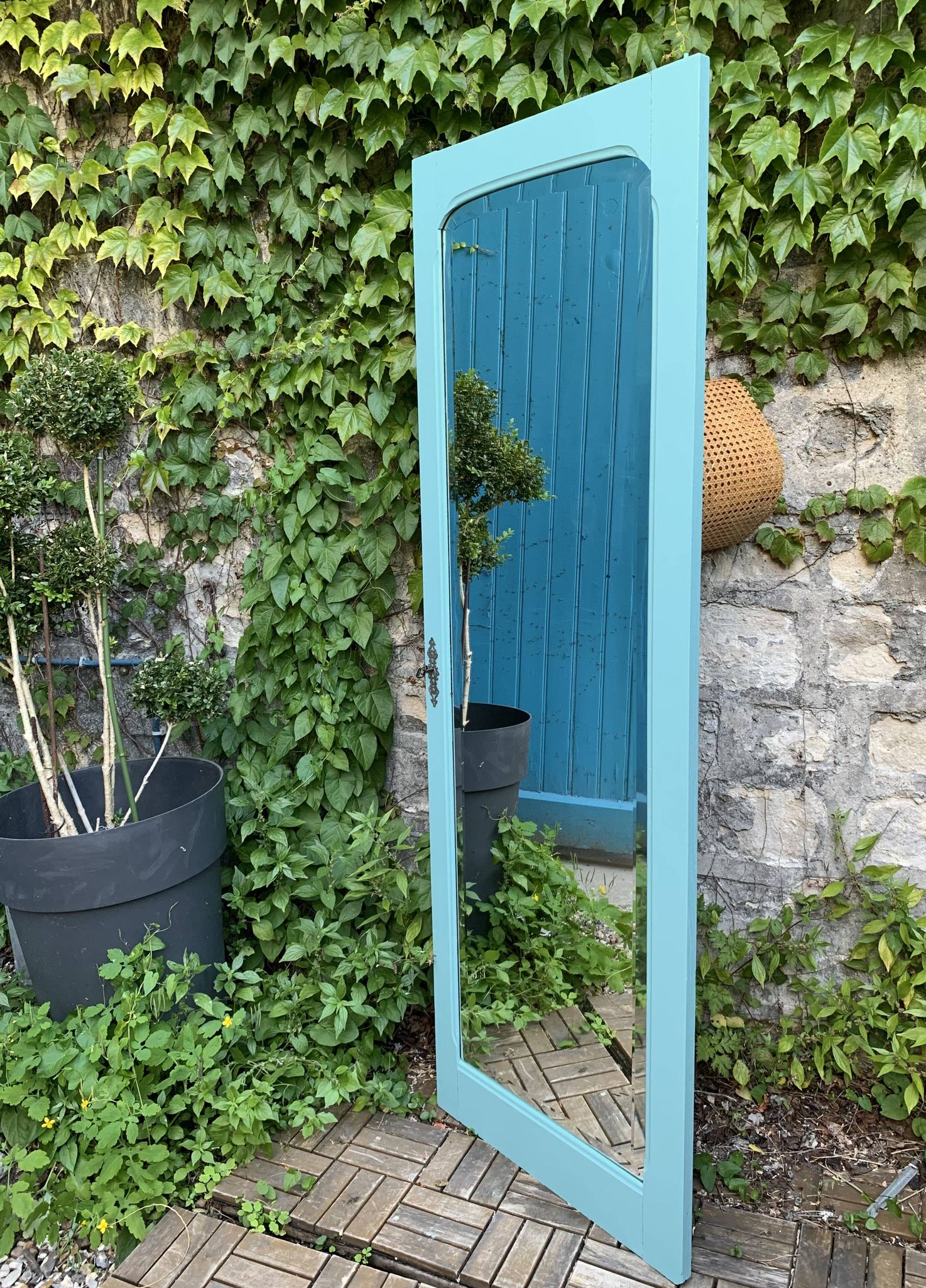 Beveled mirror on turquoise Parisian door