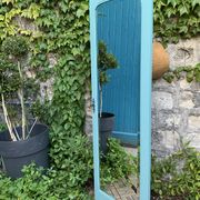 Beveled mirror on turquoise Parisian door