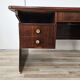 Art Deco executive desk in exotic wood, glass, and brass.