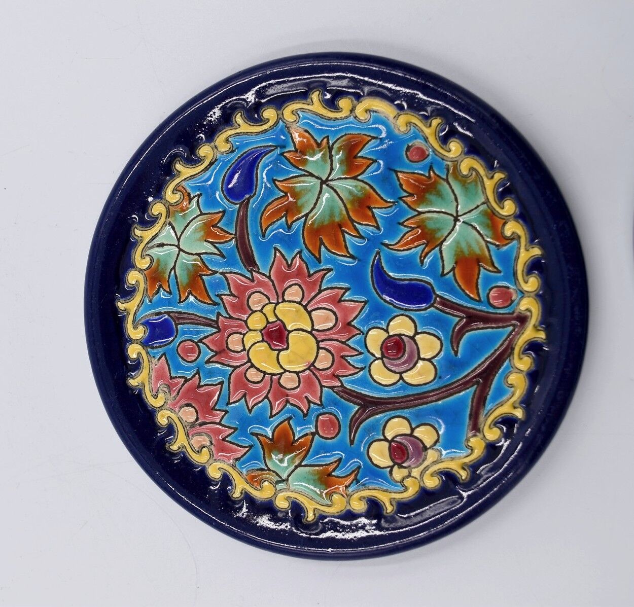 A flat bottom and two enamel bottle bottoms of Longwy