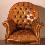 Office chair known as a presidential chair in mahogany and cognac leather.