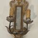 Pair of wall sconces in carved wood and silvered and gilded patinated metal with a central mirror.