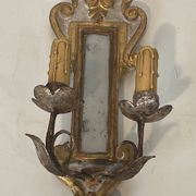 Pair of wall sconces in carved wood and silvered and gilded patinated metal with a central mirror.