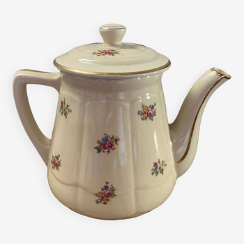 Old teapot or coffee maker in English style.