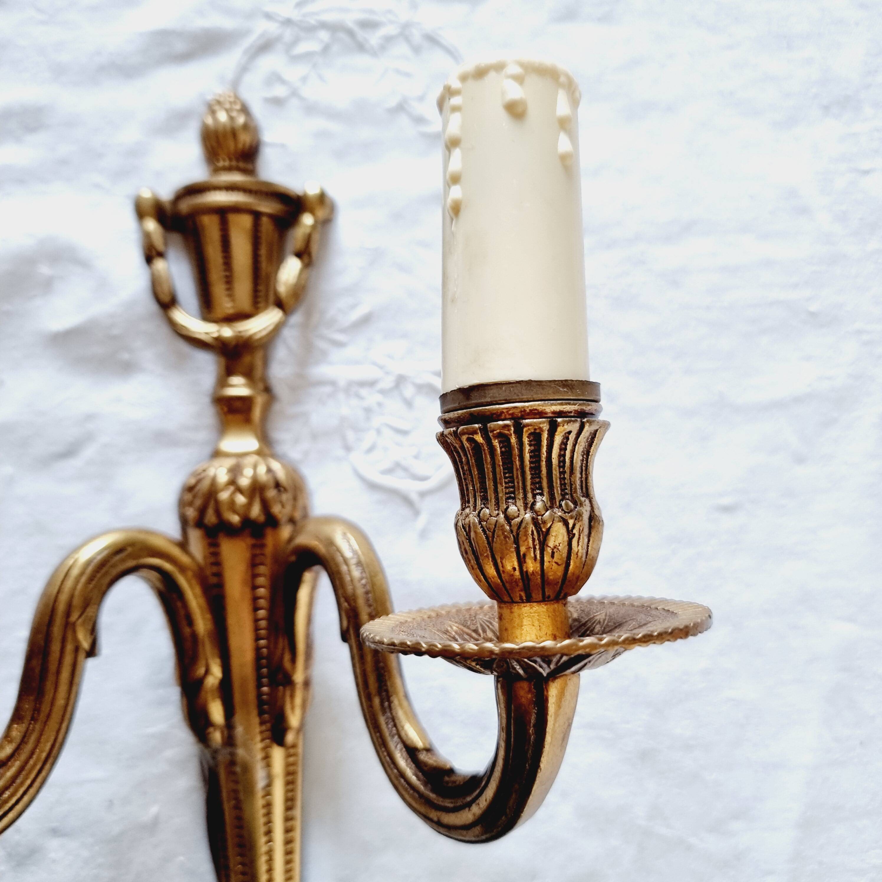 French Empire-style wall sconce or chandelier in bronze with an antique gold patina.