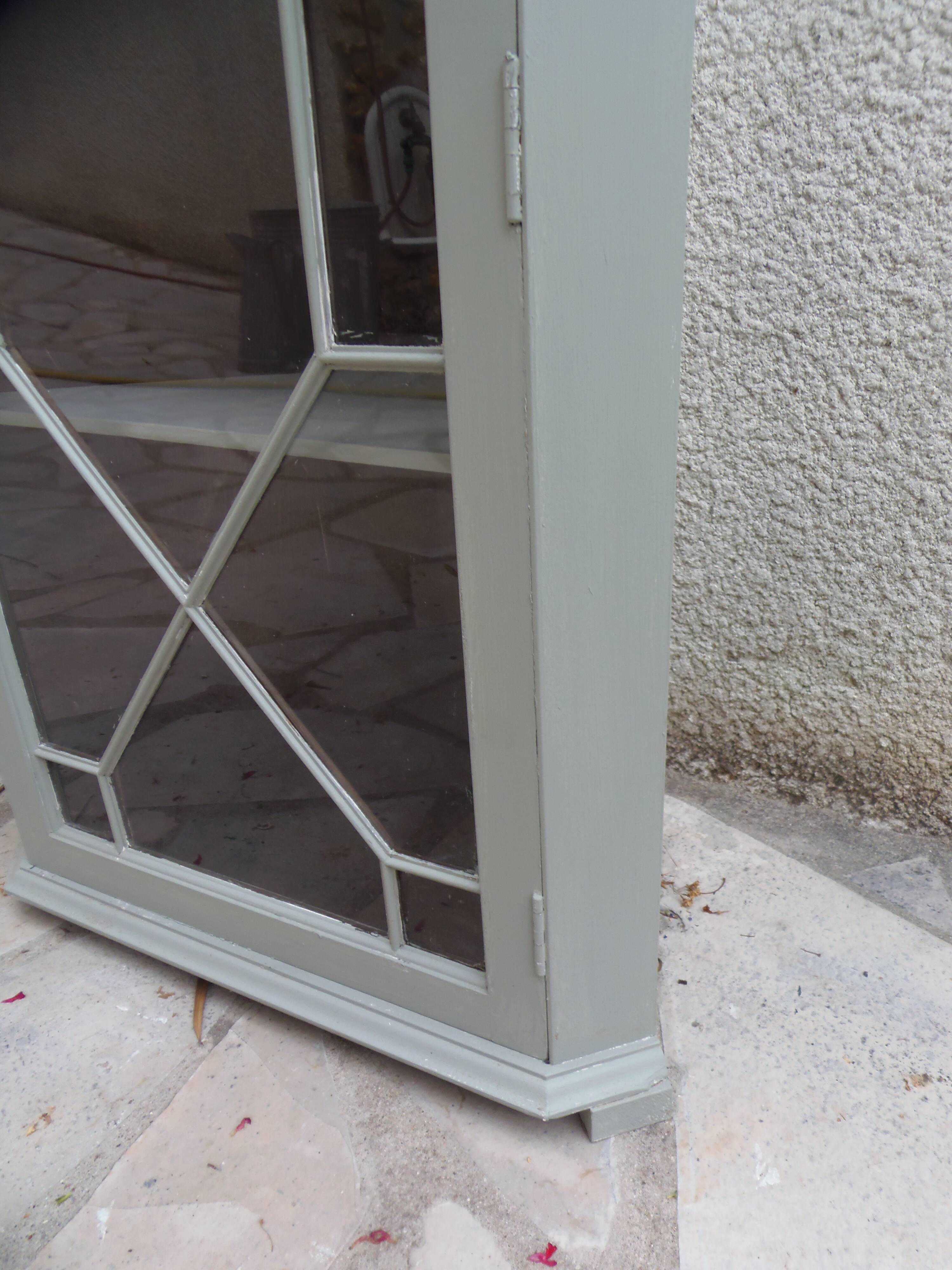 Vintage English corner display cabinet enhanced in grey-green with a wooden top.