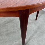 Round teak table with Scandinavian design extensions from the 60s vintage