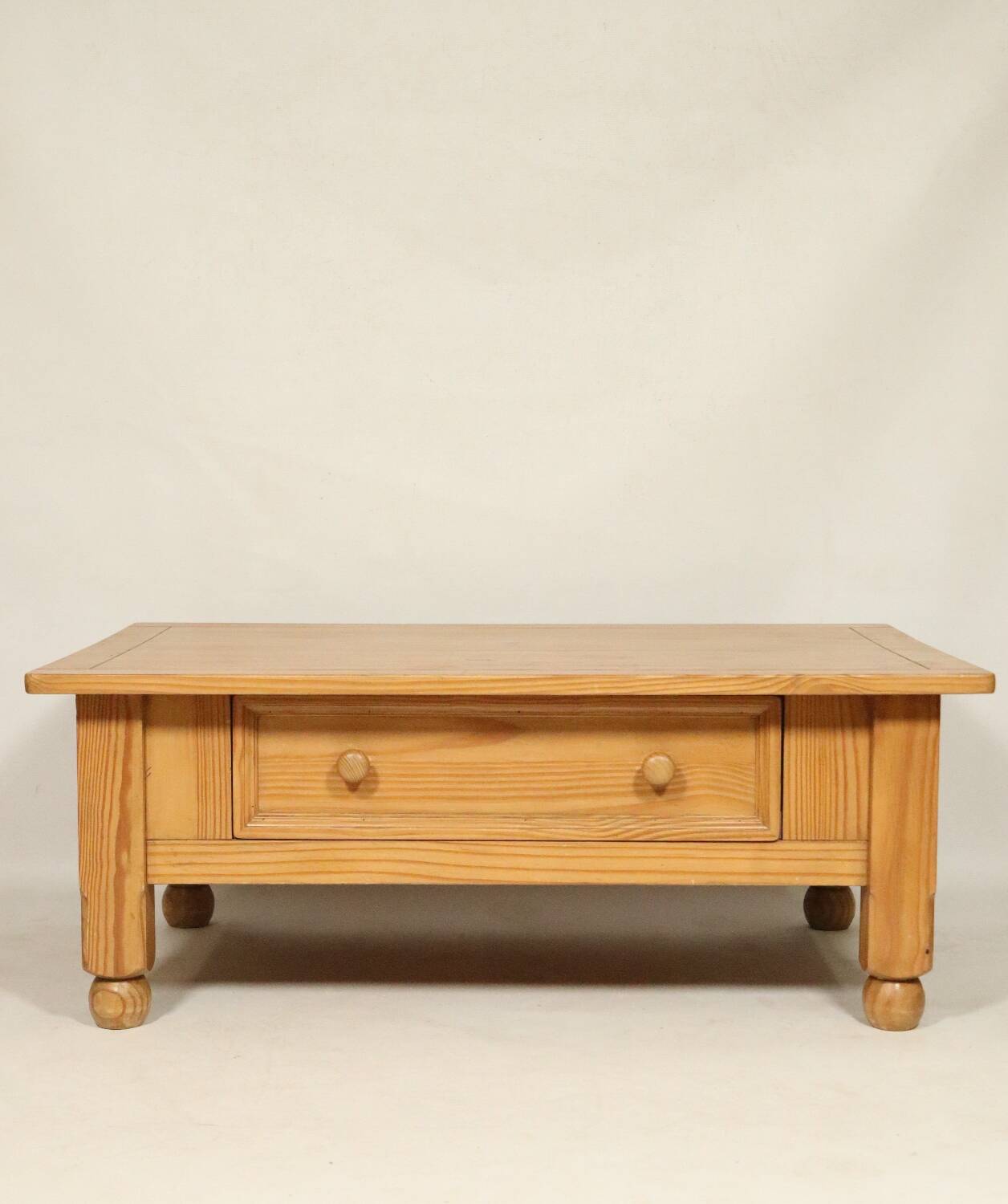 Rustic vintage style coffee table in light wood, mid-century modern design.