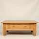 Rustic vintage style coffee table in light wood, mid-century modern design.