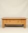 Rustic vintage style coffee table in light wood, mid-century modern design.