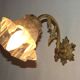 Simple wall sconce in French Art Nouveau bronze with a white glass shade featuring patterns.