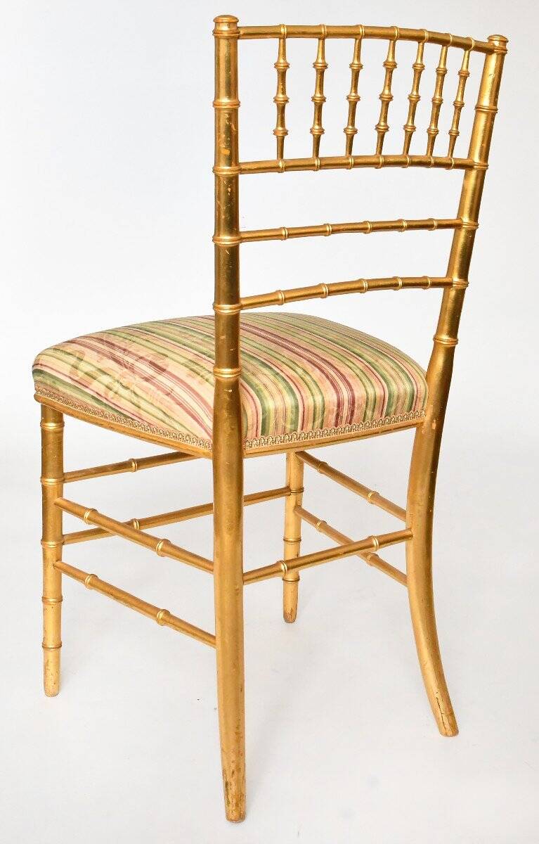Pair of golden wood chairs in a bamboo style.