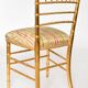 Pair of golden wood chairs in a bamboo style.