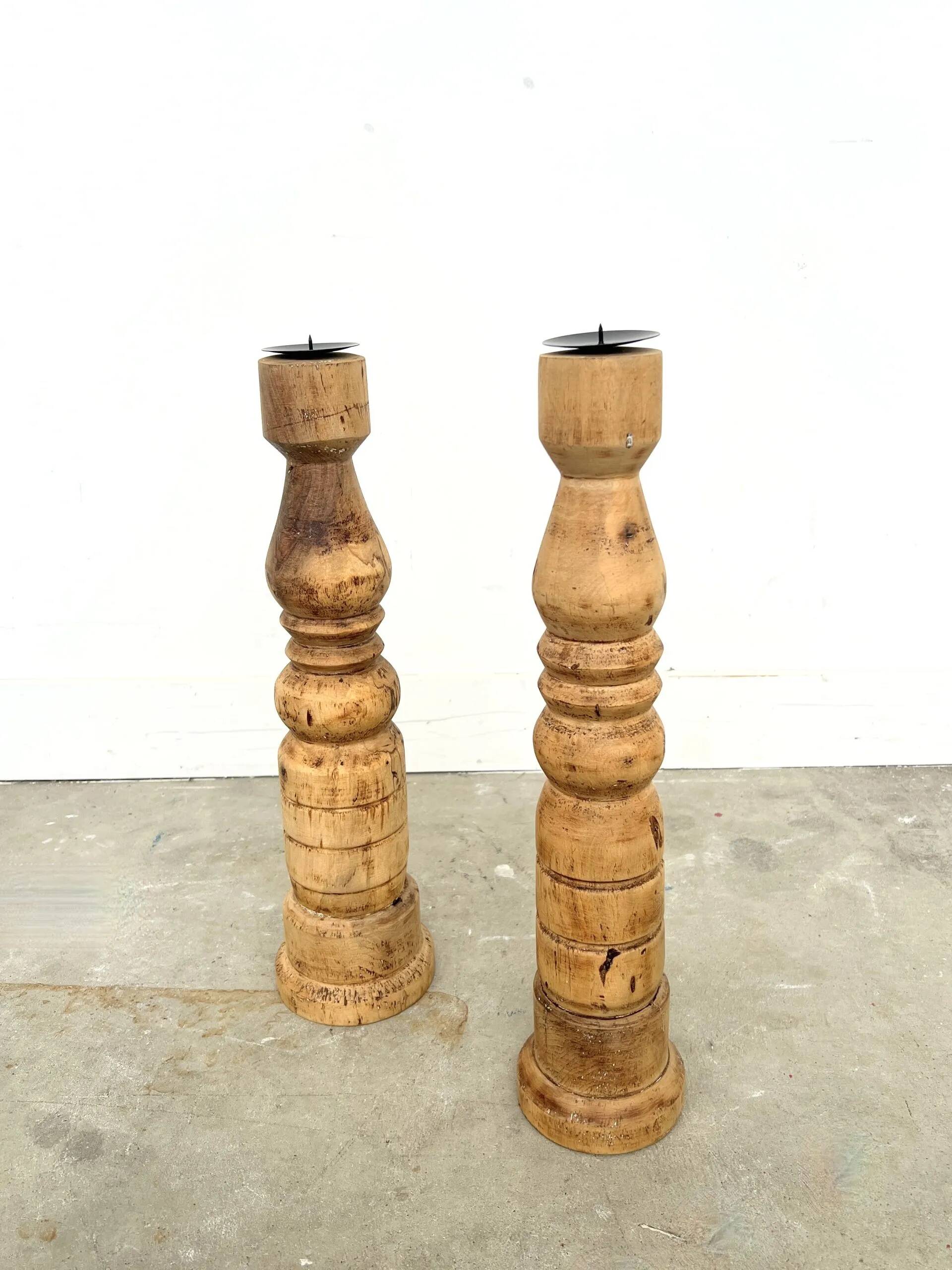 Pair of turned wooden candlesticks, raw and waxed.