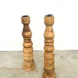Pair of turned wooden candlesticks, raw and waxed.
